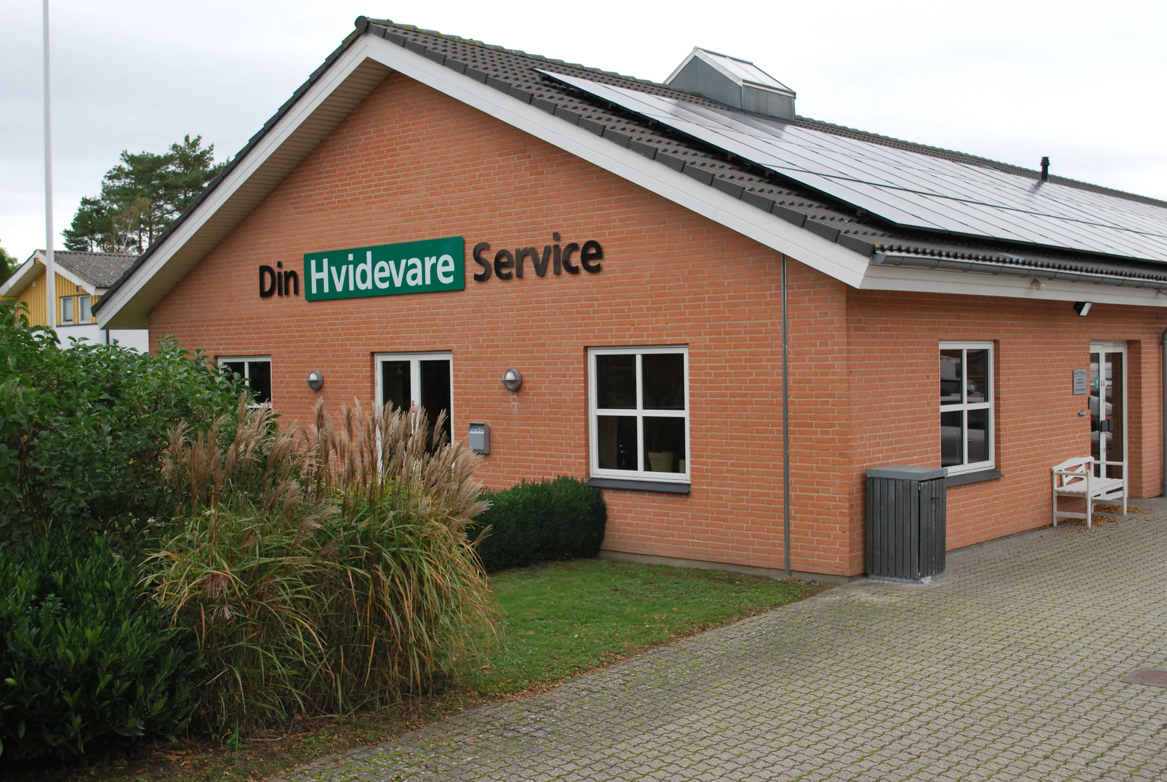 Din Hvidevare Service's building with solar panels on the roof