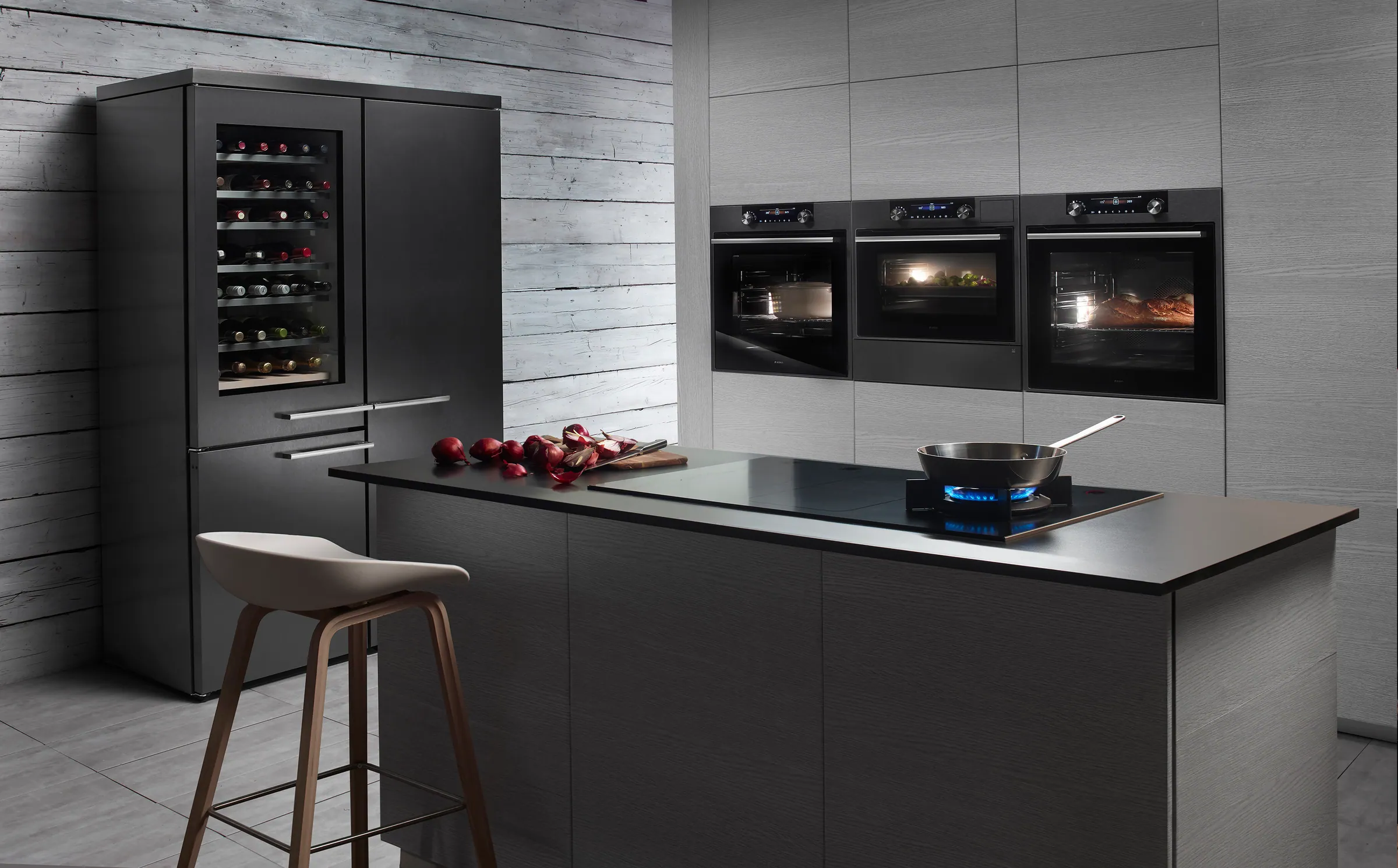 Modern kitchen with a wine cooler, built-in ovens and a cooking island