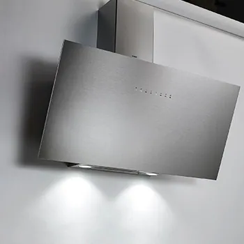Angled stainless steel cooker hood with its lights on
