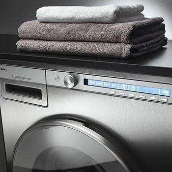 Stainless steel washing machine with towels on top